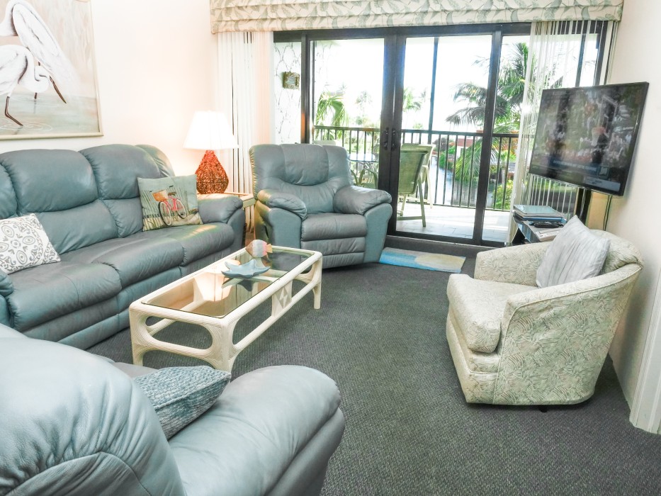 Watch the large TV from reclining sofas in Living room.