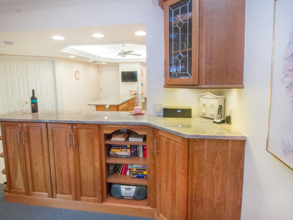 Entertainment area stocked with a variety of glassware, games, books, and puzzles.