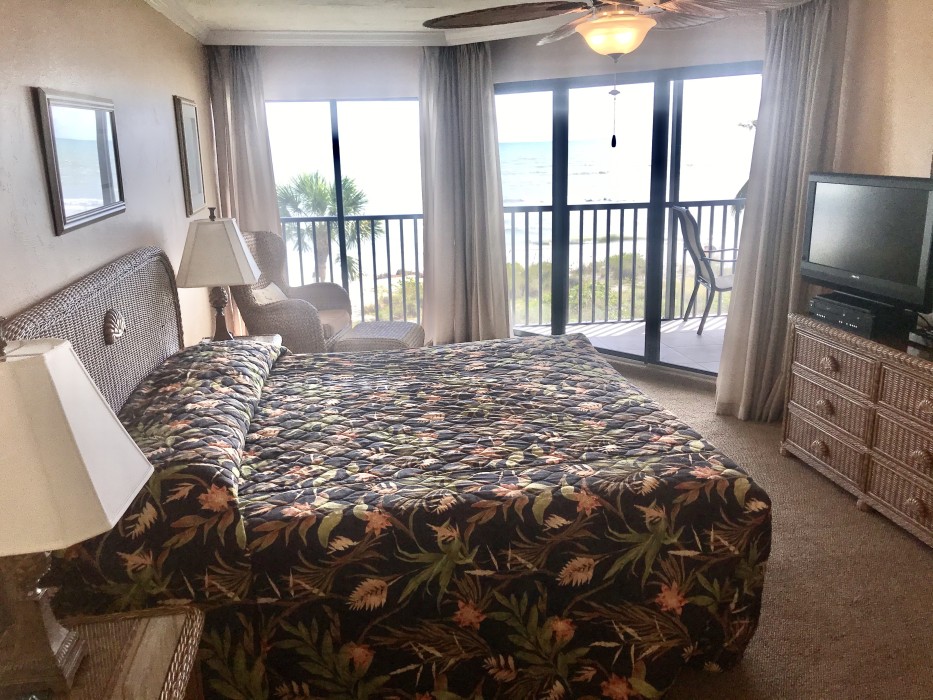 The master bedroom with a king size bed and view of the beach