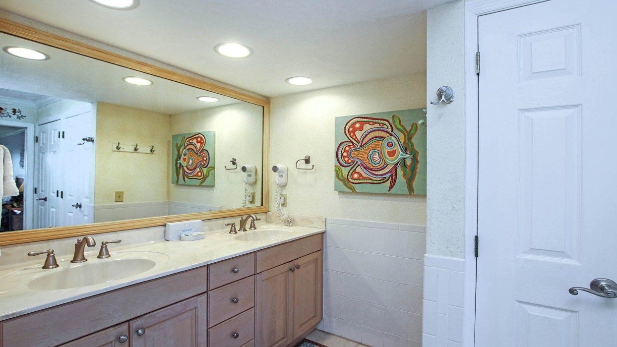 The master bathroom has double sinks and a marble-tiled shower.  The sink cabinet was recently painted a soft sage green and has a new quartz countertop and new sinks; new photos of the updates will be added soon.