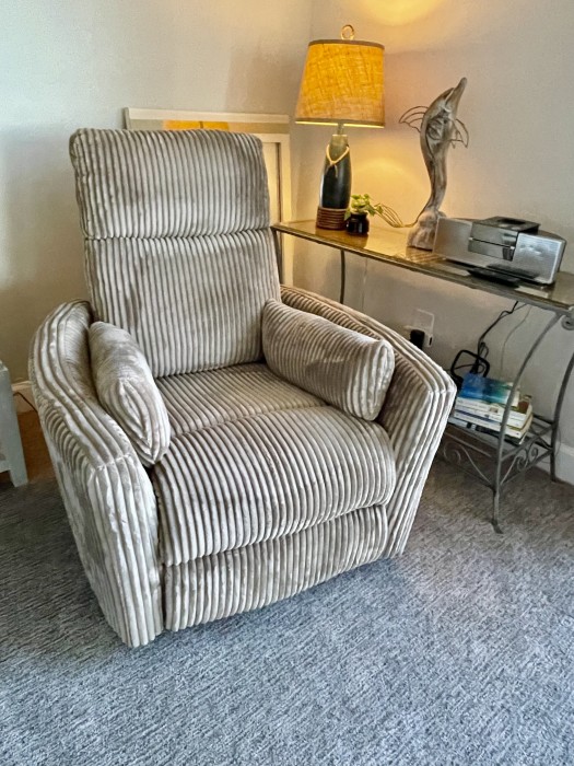 Enjoy the little brown chair while watching a 50”TV