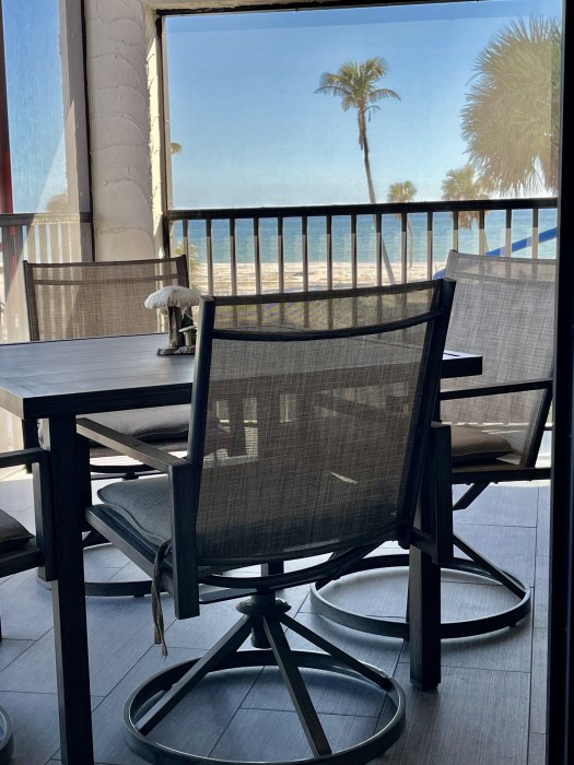 Relax on the Lanai with gulf breeze and a  prime view of the Gulf, courtyard lagoon, and pool