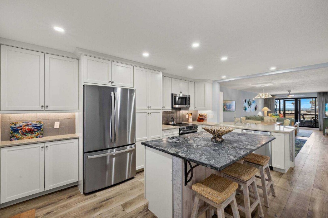 The Kitchen as you enter Turtle Daze.  All new appliances and beautiful Quartzite countertops with breakfast seating.