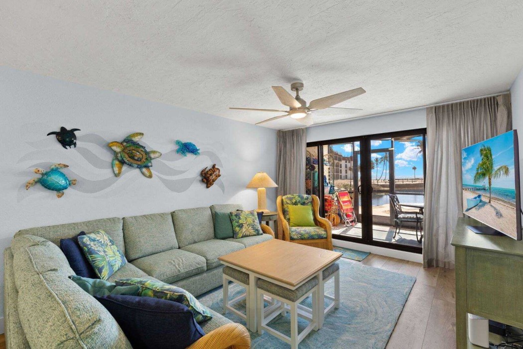 Living Room with sliding door to the Lanai and view to the Lagoon and Gulf.