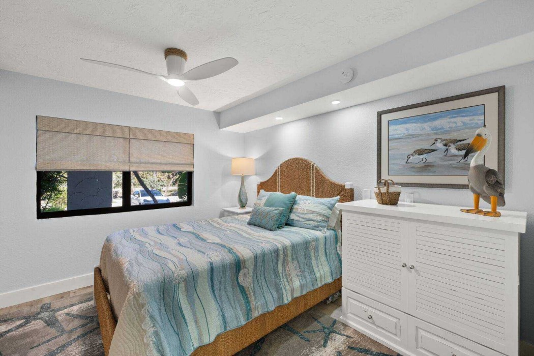 Guest Bedroom 1 with a queen bed and a cabinet with a fold out twin.