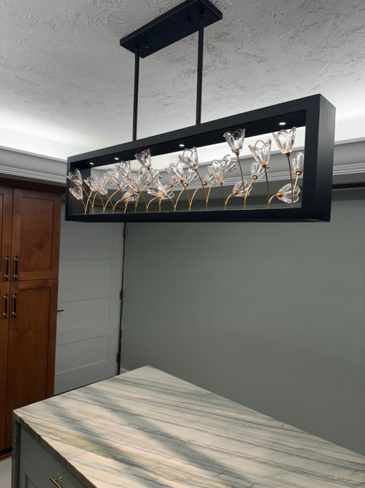 Details from ceiling to floor.  Beautiful stone tops, crystal lights and organized supplies for any cook