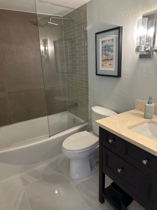 The tub features both a rain head and hand held shower with easy to reach controls