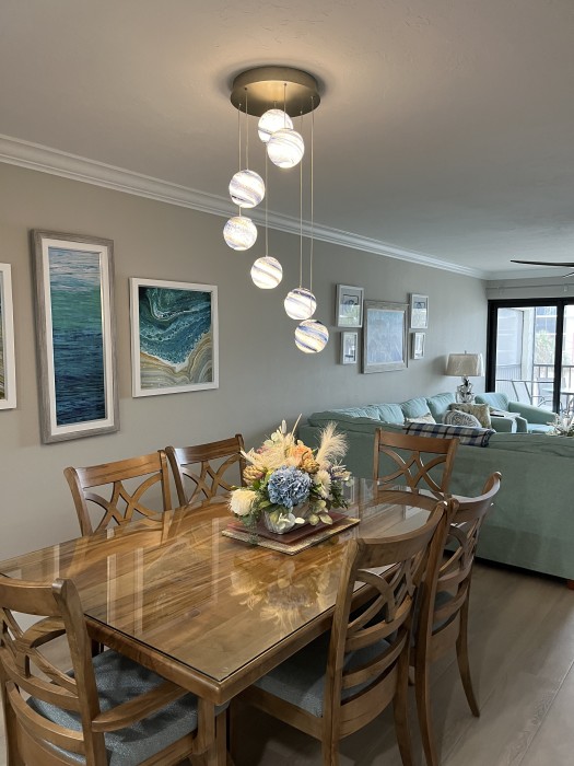 Exotic wood dining table with artist hand blown chandelier globes