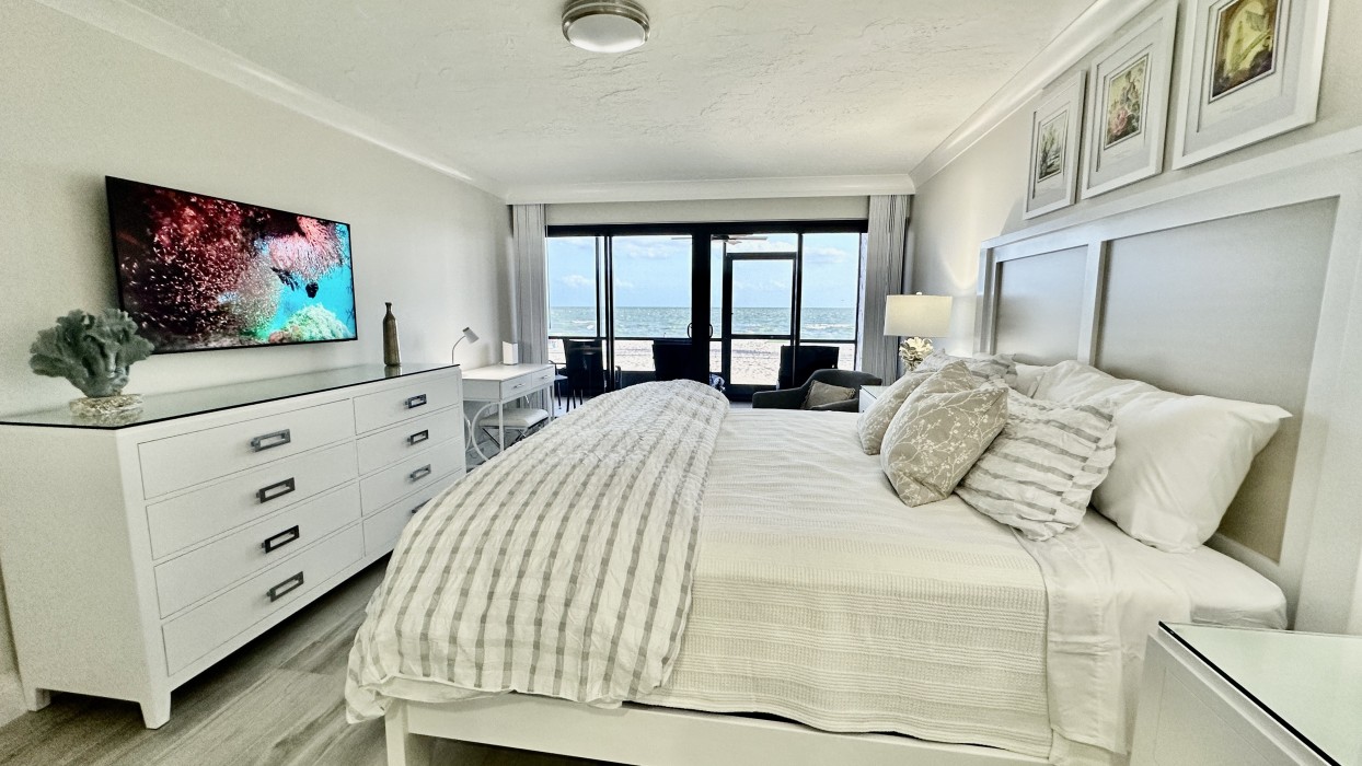 There is a club chair, writing desk/vanity, Smart TV and lanai access.