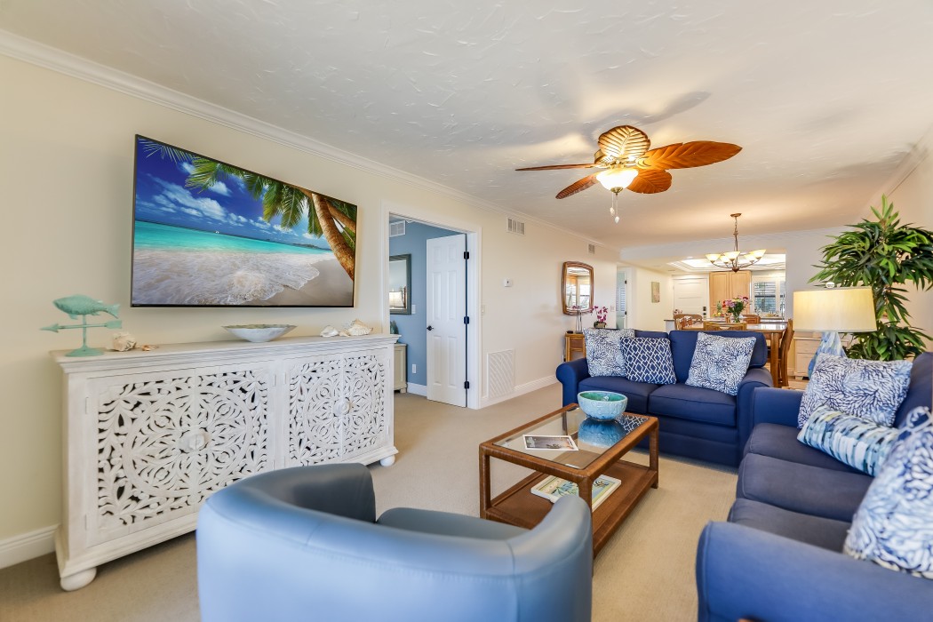 Living Room with a 65 inch television. Games, books and puzzles are located inside of the console under the televsion.
