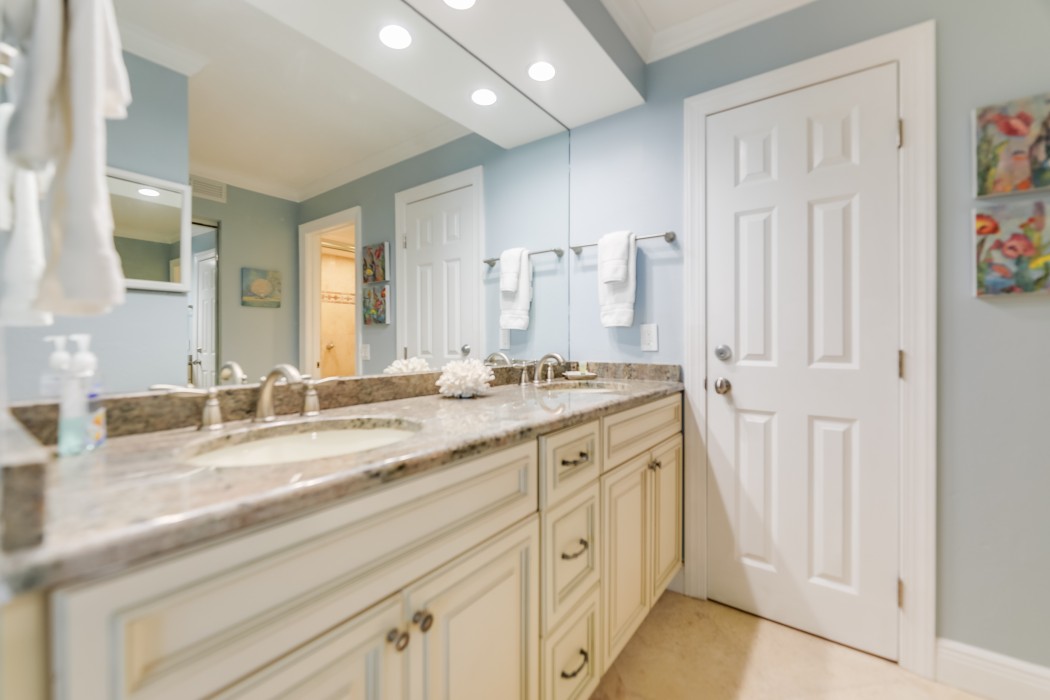 Double sinks and plenty of space. A makeup mirror and hairdryer are located under the sinks.