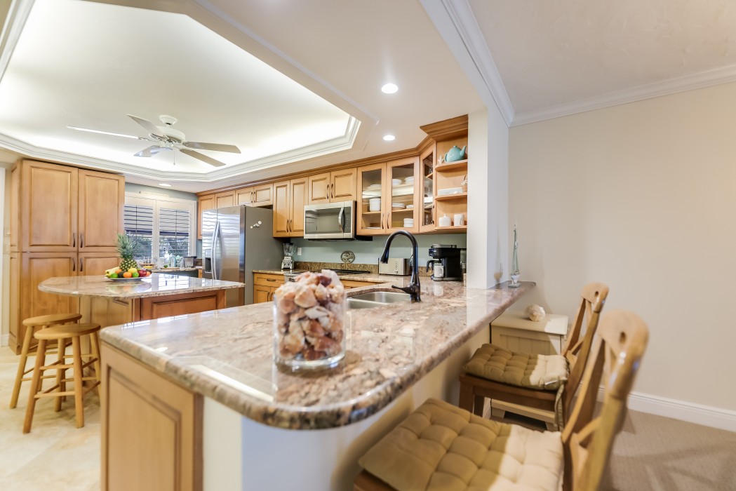 Beach towels, umbrellas and accessories are stored in the tall cabinet. Kitchen includes a variety of items.