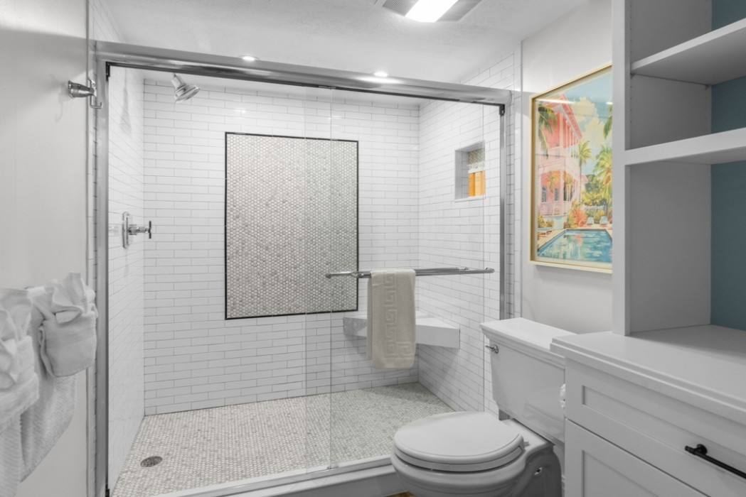 Oversized shower and additional storage in a privacy commode/bathing room in Master Bath