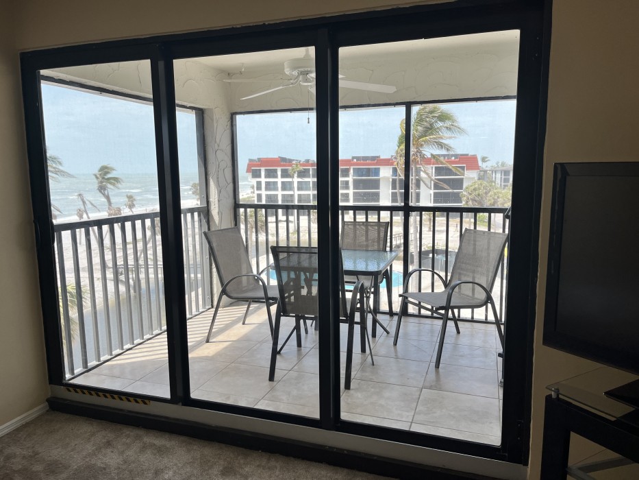 Screen-in lanai overlooking the lagoon and pool