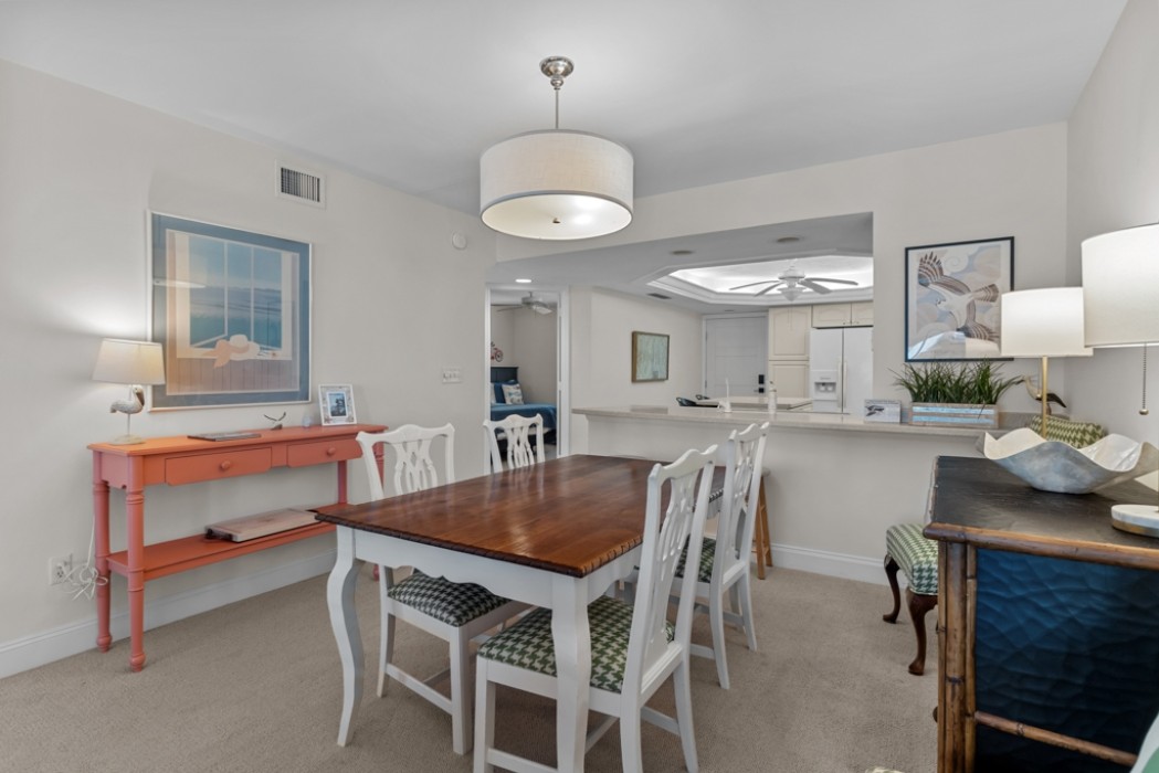 Dining table w/ 4 chairs and bar stools near the bar