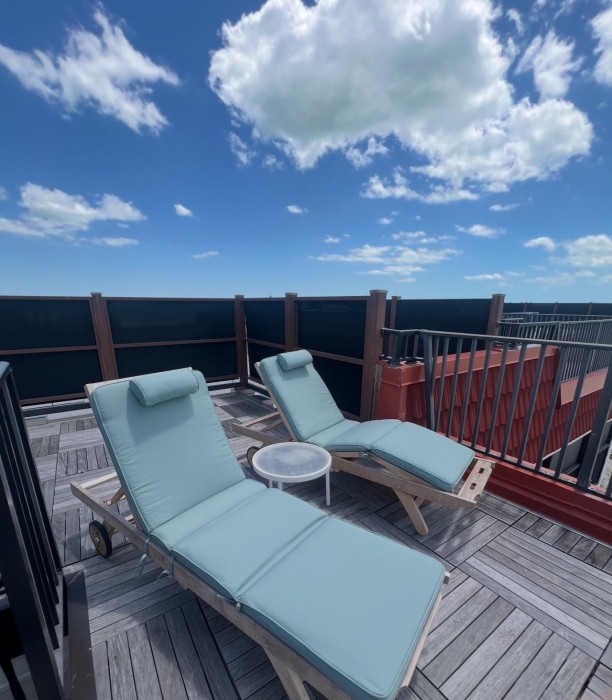 Comfy loungers on the private penthouse deck.