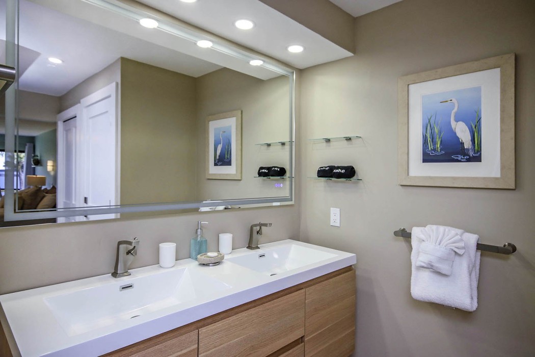 All new master bath with walk in shower and double sinks in a floating vanity and lighted mirror