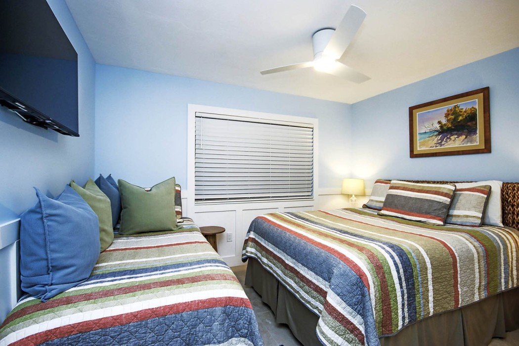 The second bedroom is reconfigured with a queen and a twin bed
