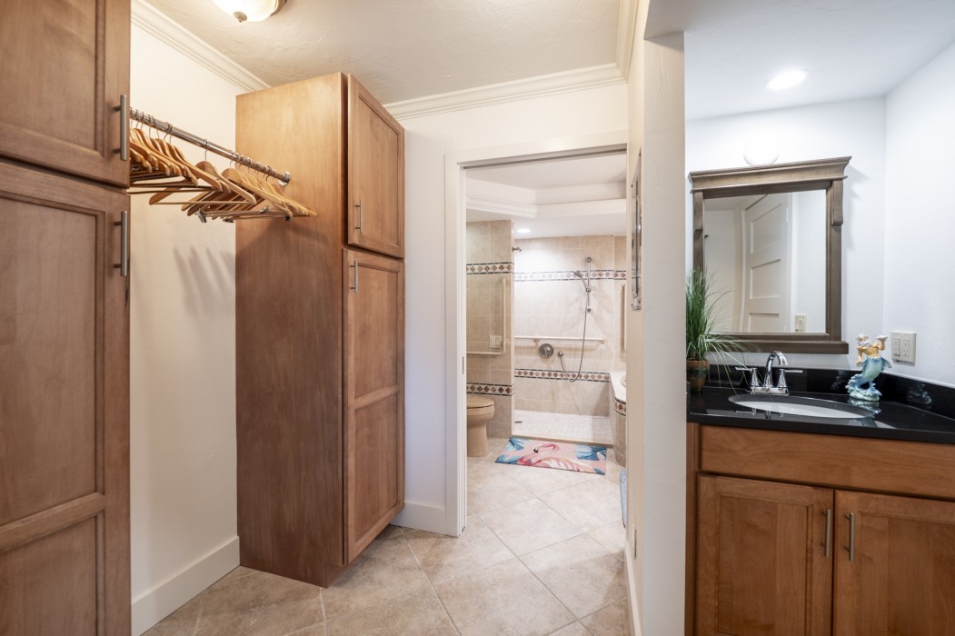 The master suite has a dressing area with a vanity sink and walk-in closet