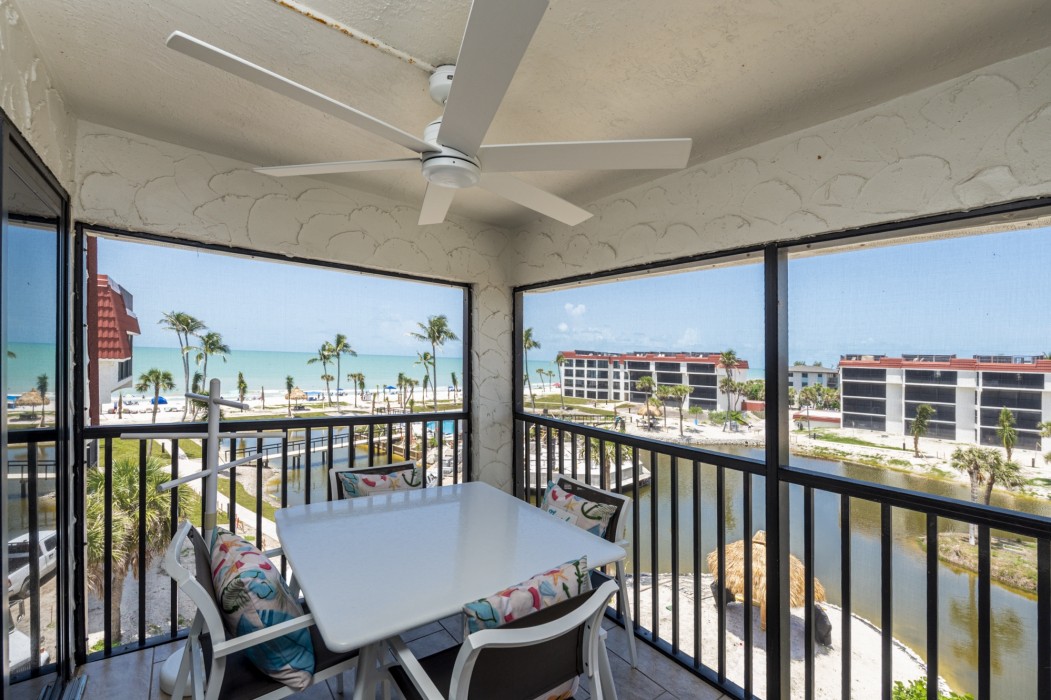 The screened porch has a great view of the pool and the Gulf