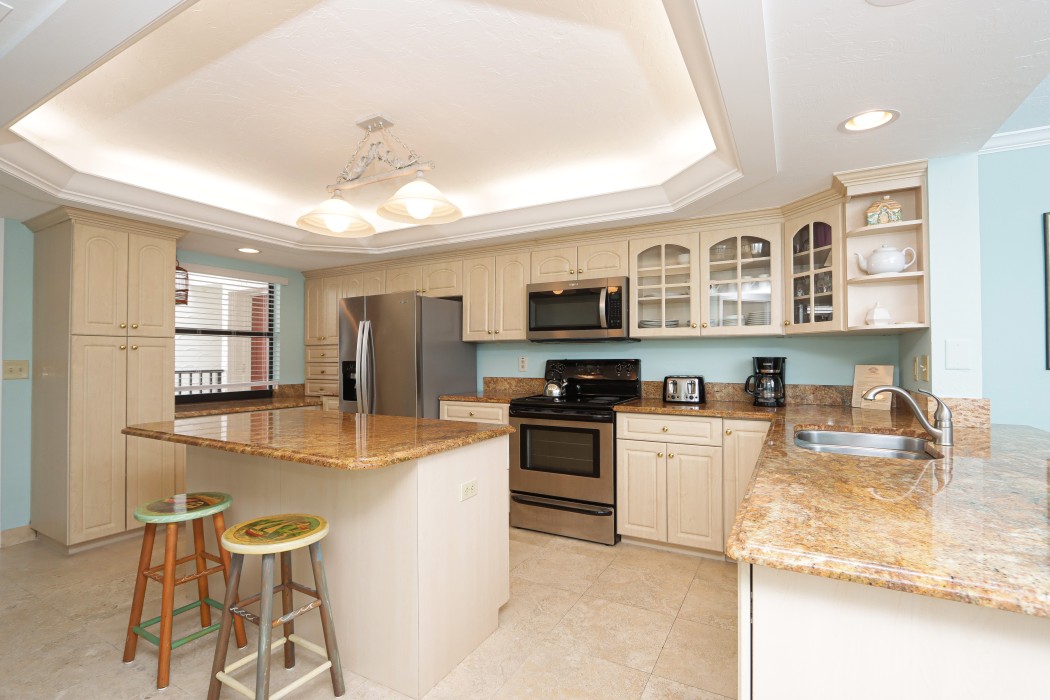 Kitchen with breakfast bar and stainless steel appliances.