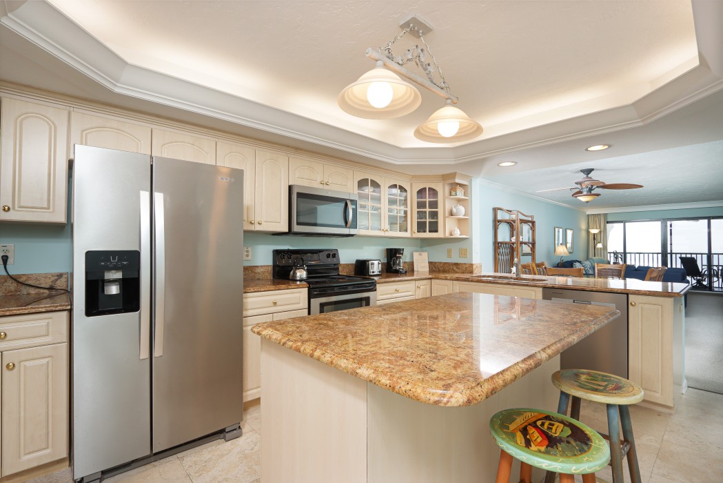 Kitchen with breakfast bar and stainless steel appliances.
